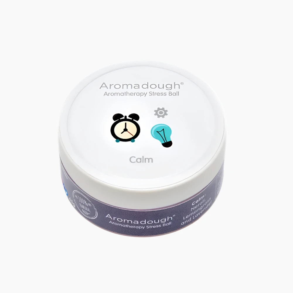 Aromadough aromatherapy stress ball with a white lid and purple body on a white background